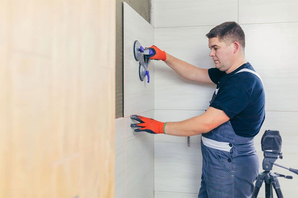 man installing shower panels